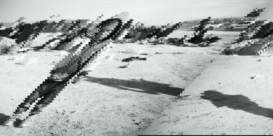 Syrian child standing in desert
