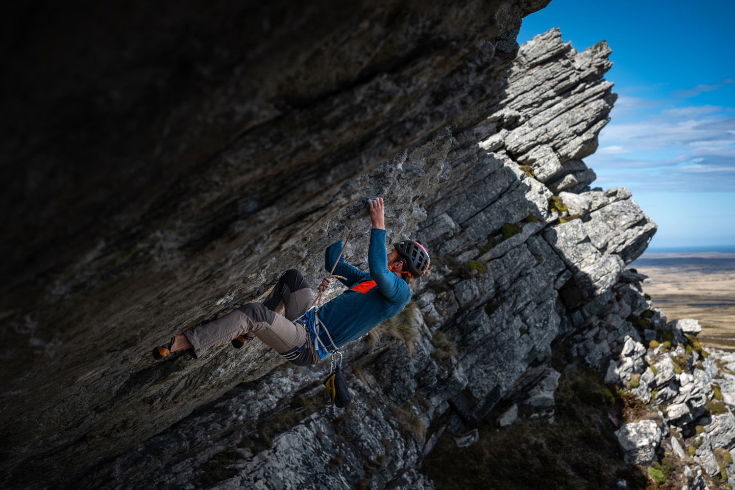 A climber traverses a rocky outcrop.