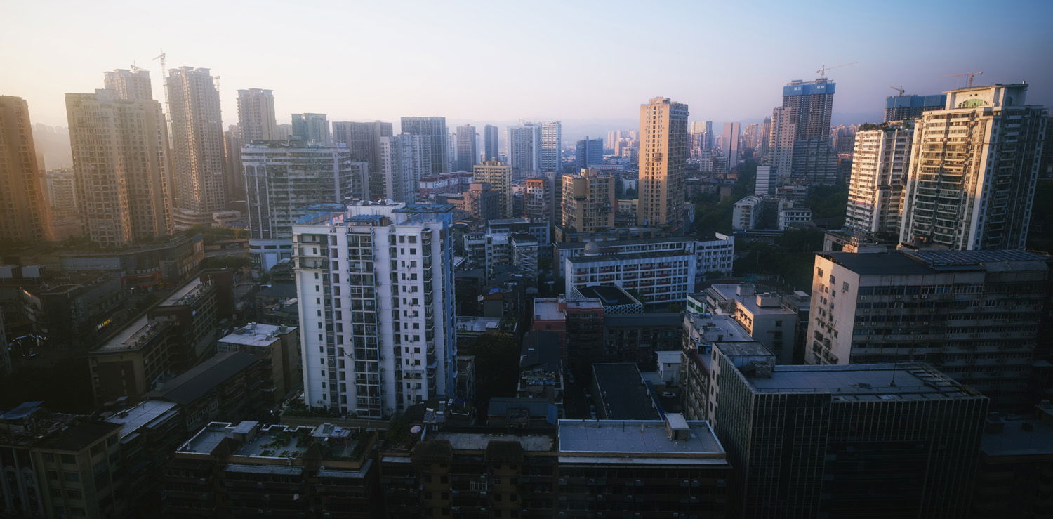 Busy cityscape of skyscrapers under cool blue sky