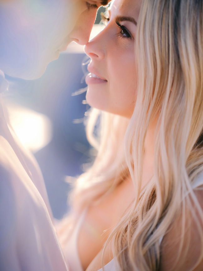 Close up of man and woman in an intimate nose to nose position and looking into each other's eyes