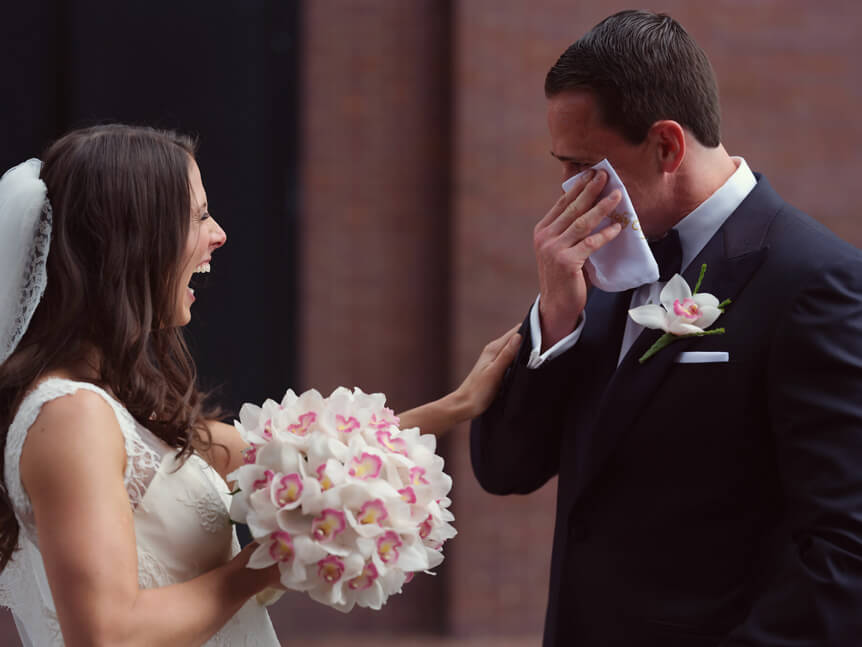Professional photographer, Alison Conklin, on why the FUJIFILM GFX system is so good for location portrait photography. Image shows a groom crying tears of joy on his wedding day and being comforted by his bride.
