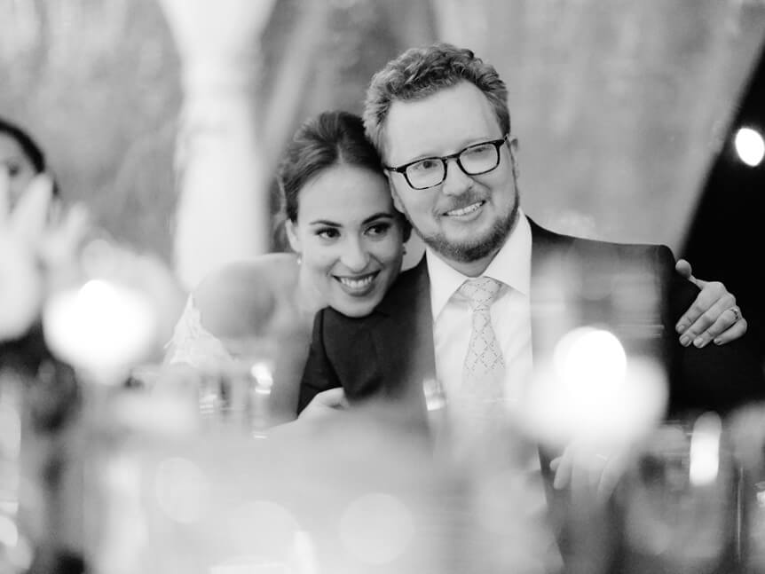 Professional photographer, Alison Conklin, on why the FUJIFILM GFX system is so good for location portrait photography. Image shows black and white photograph of bride and groom listening to wedding day speeches.