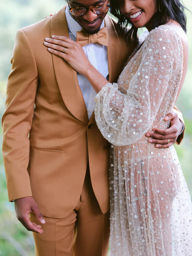 Professional photographer, Alison Conklin, on why the FUJIFILM GFX system is so good for location portrait photography. Image is a mid-shot of a bride and groom hugging on their wedding day.