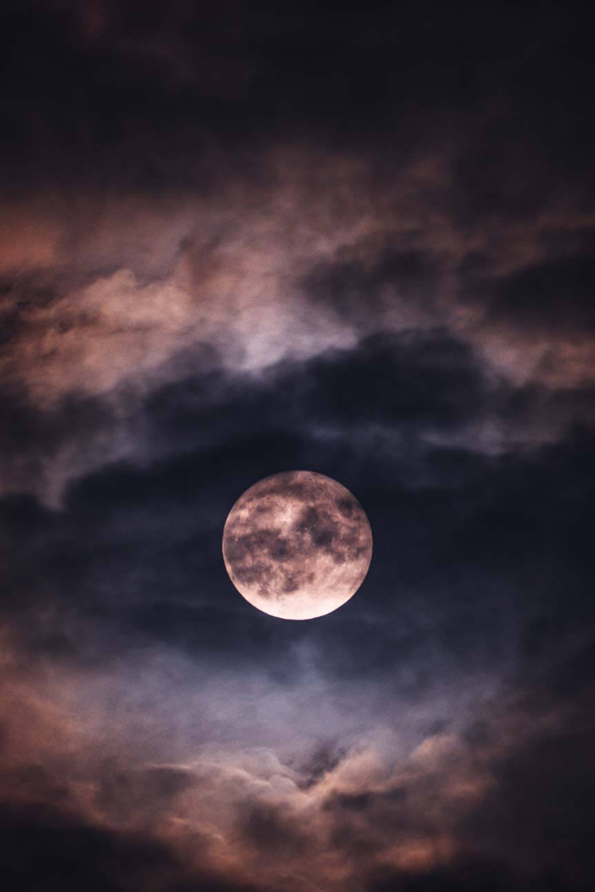 Full moon behind clouds