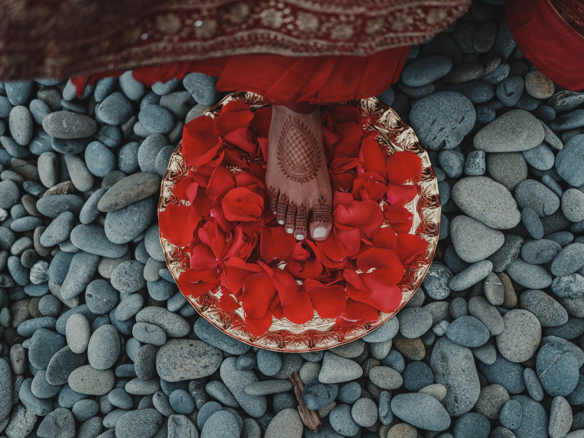 An Indian bride steps in traditional decorations