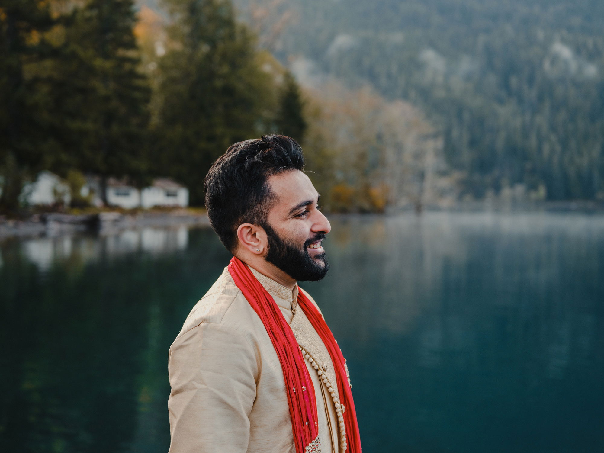 Wearing traditional Indian wedding garb, a groom awaits the 'first look' at Lake Crescent in Washington State