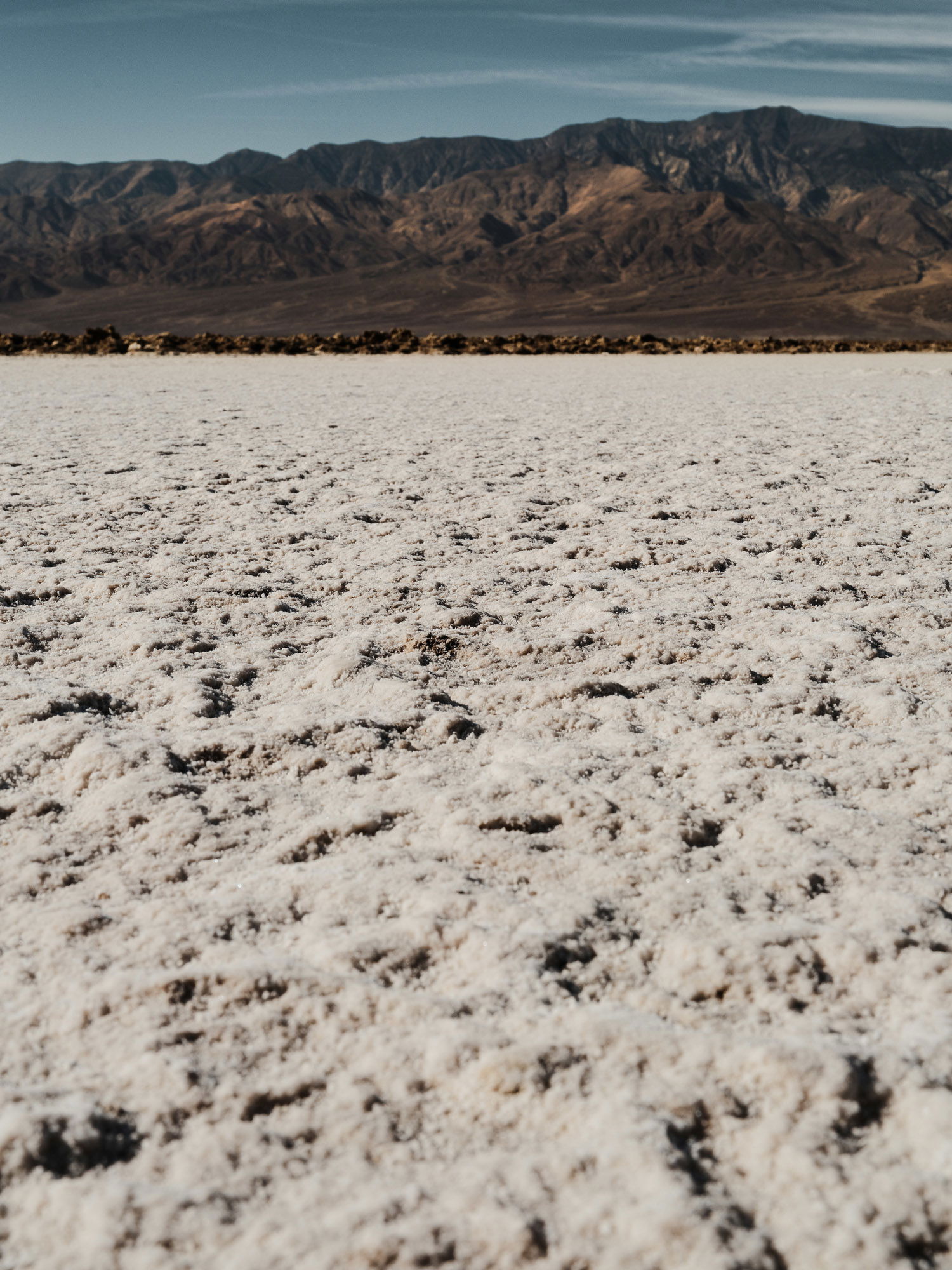 A seemingly endless floor of salt leads to mountaintops, framed on the horizon