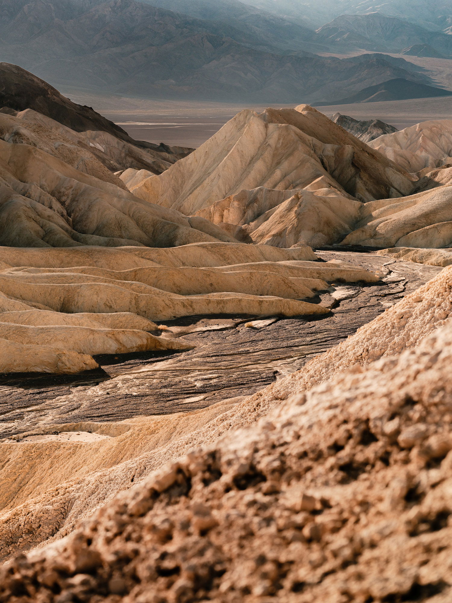 A vast frame of yellow sand dunes, surrounded by yellow peaks