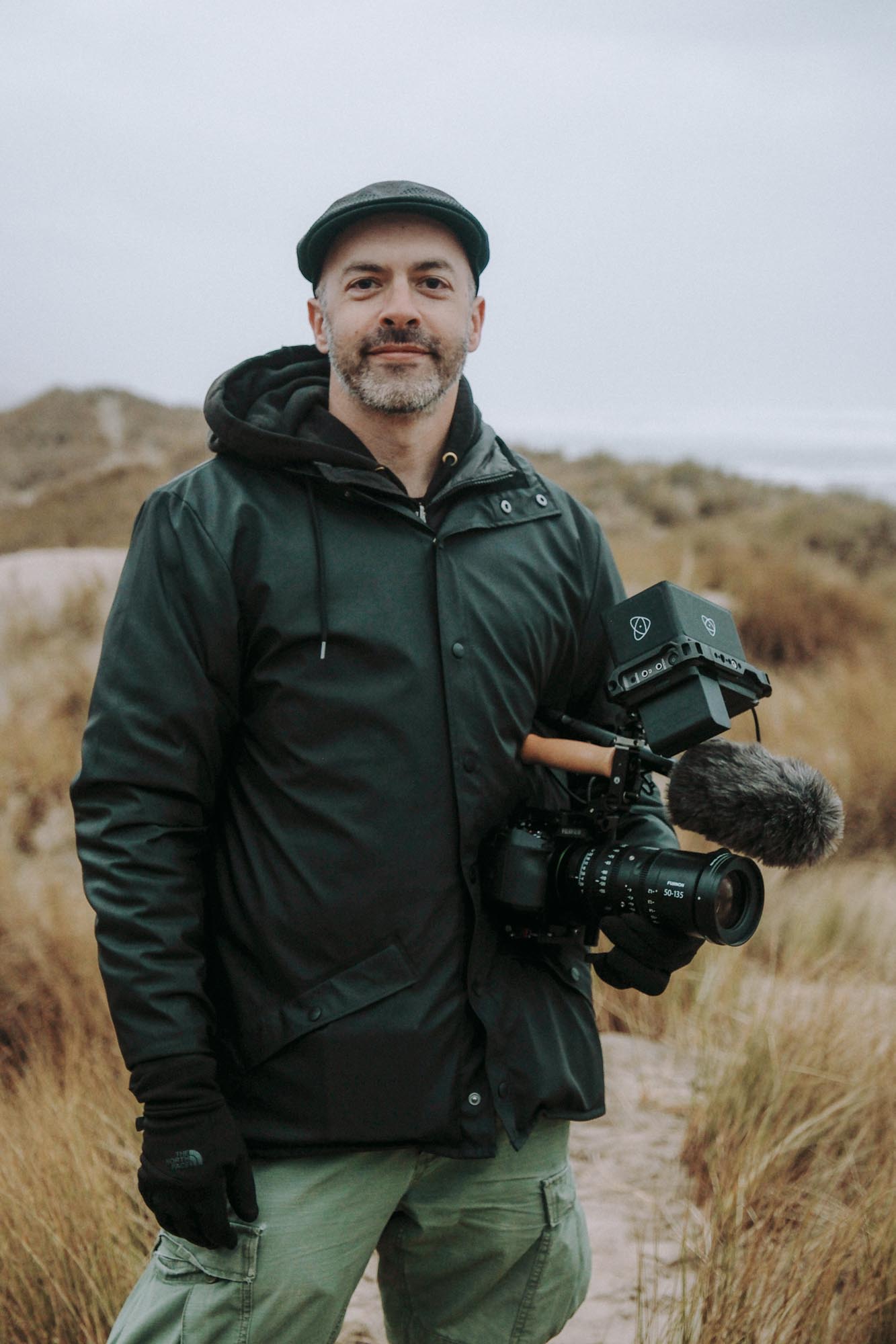 A man stands with an X-H2S in a grassy field