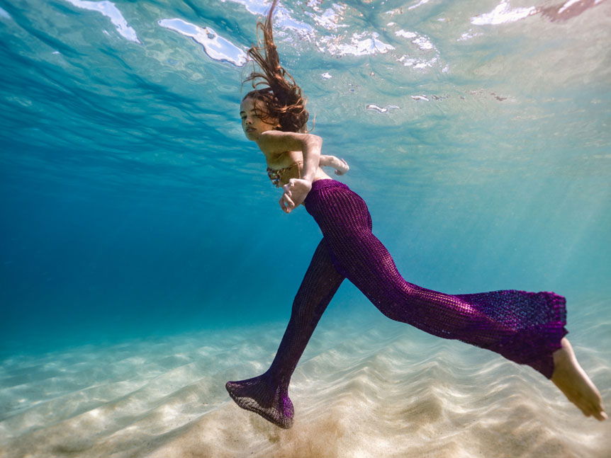 A woman walking on the bottom of the ocean