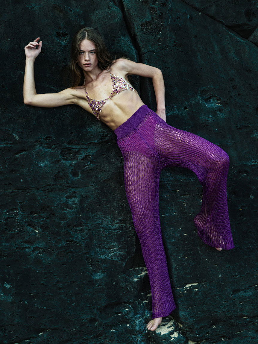 Woman wearing purple trousers posing