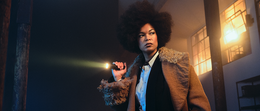 Motivated lighting shot of a woman holding a flashlight