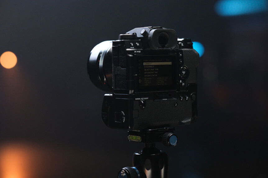 Image of the rear of FUJIFILM X-H2 camera and FT-XH File Transmitter positioned on tripod in a studio environment
