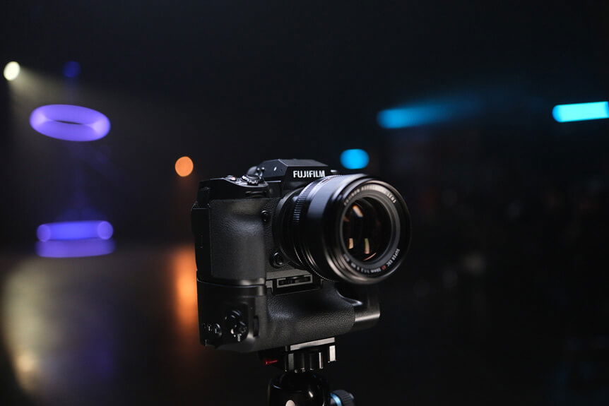 Image of the front of FUJIFILM X-H2 camera and FT-XH File Transmitter positioned on tripod in a studio environment