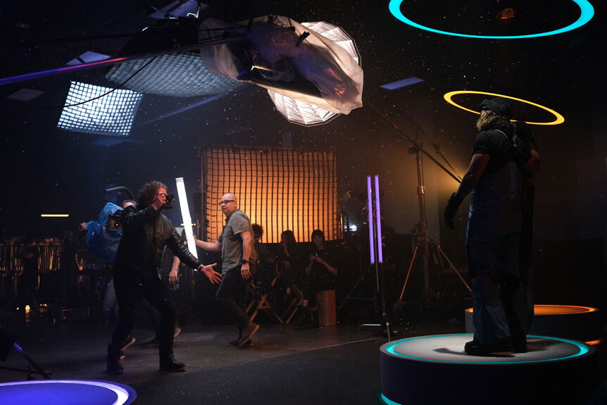 Kurt Iswarienko uses FUJIFILM X-H2 handheld to make images of a model standing on a podium in a studio environment