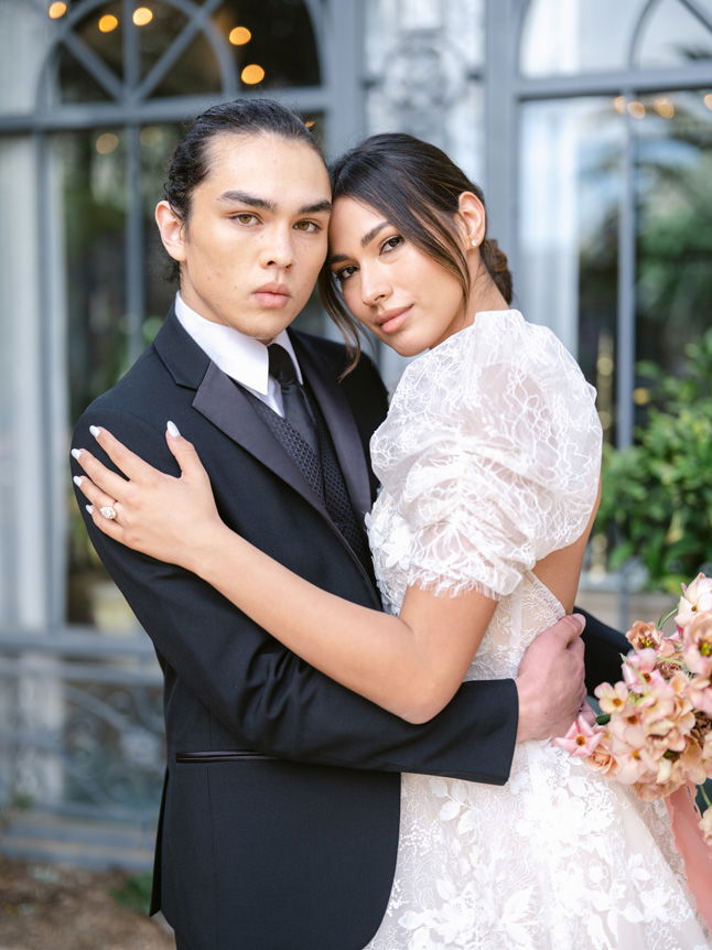 Husband and wife embrace at wedding