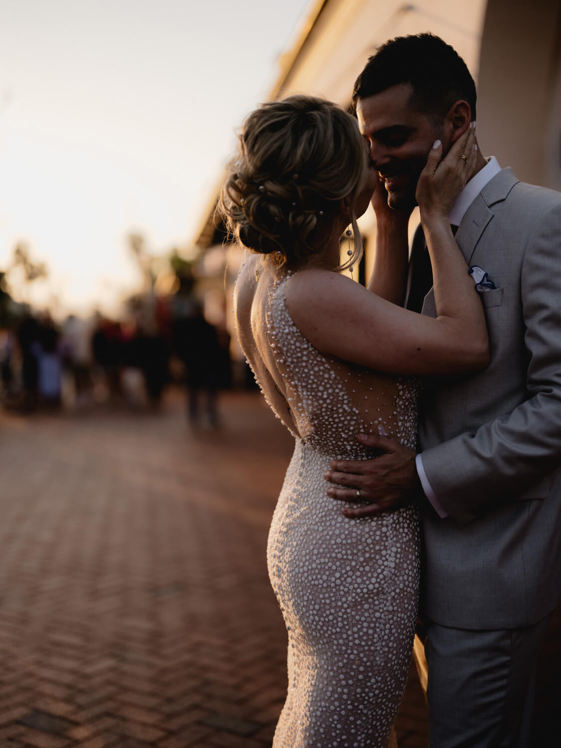 Bride and groom embracing at twilight