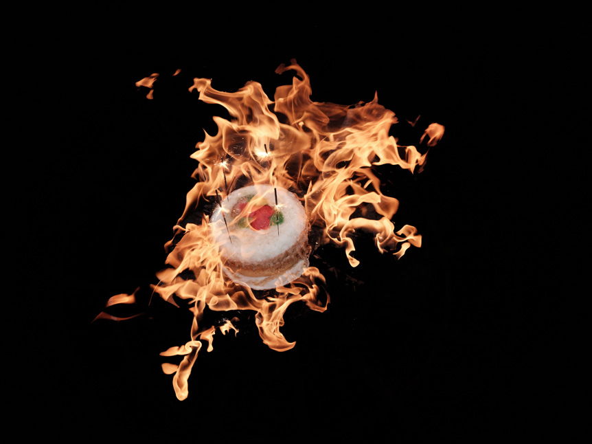 Fine art photograph. Overlay of a cake with flames