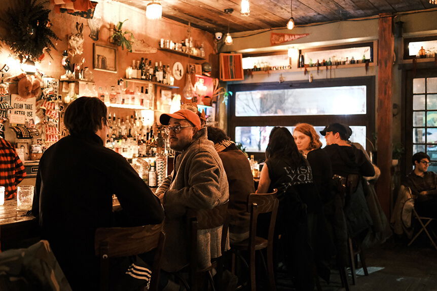 Group of people in a small, dim bar