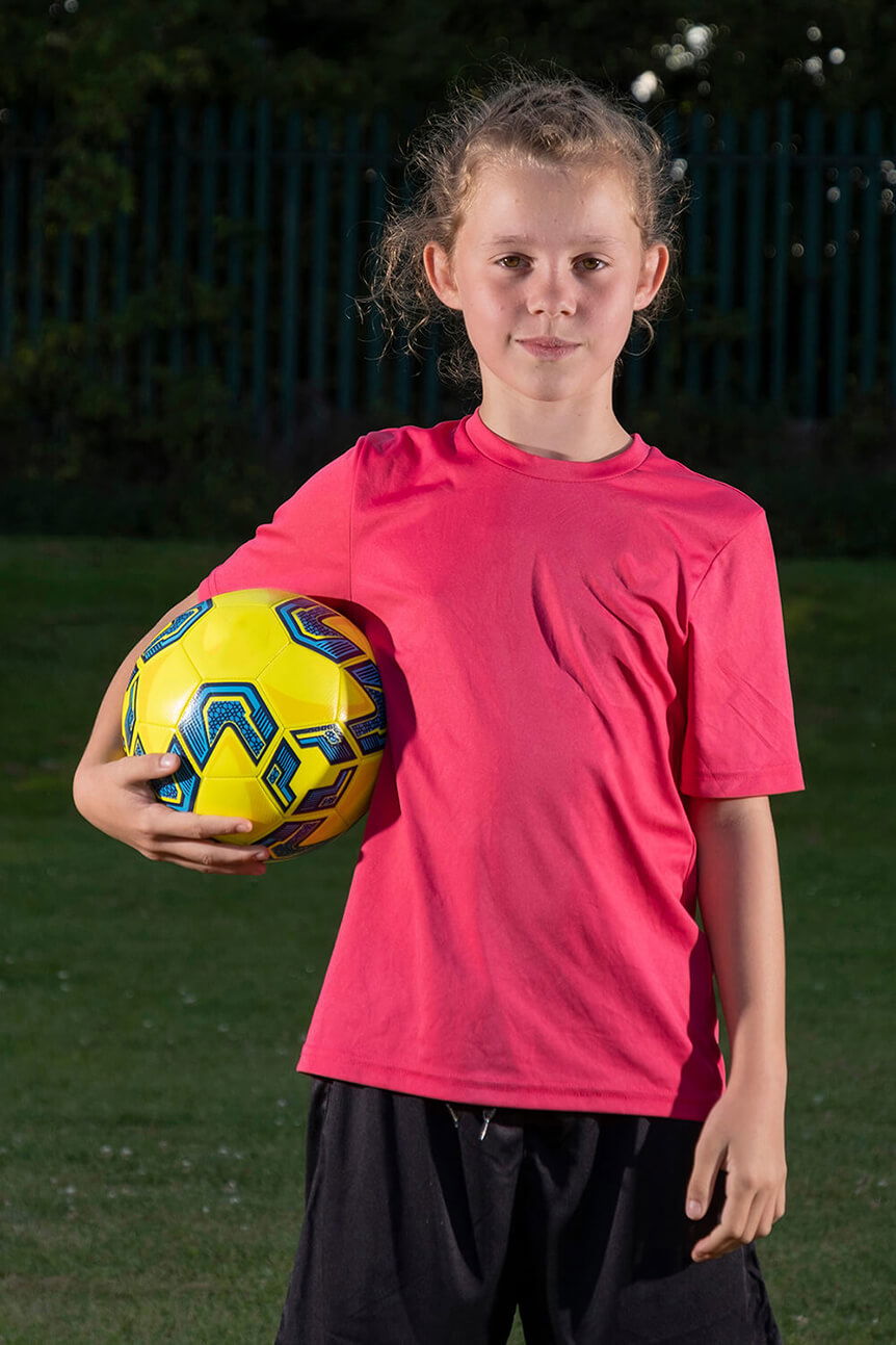 Young girl holding football